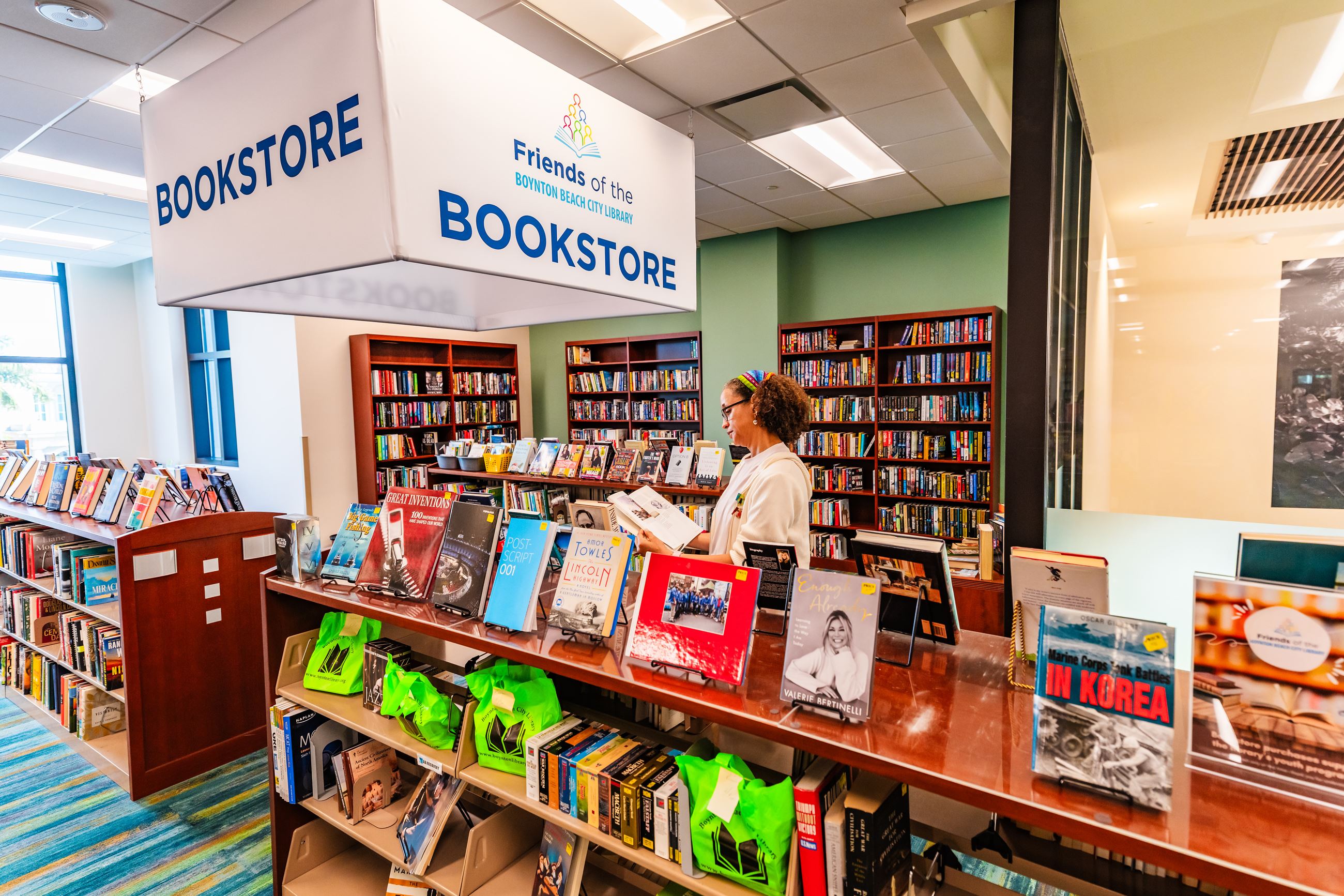 Woman standing in bookstore, reading a book